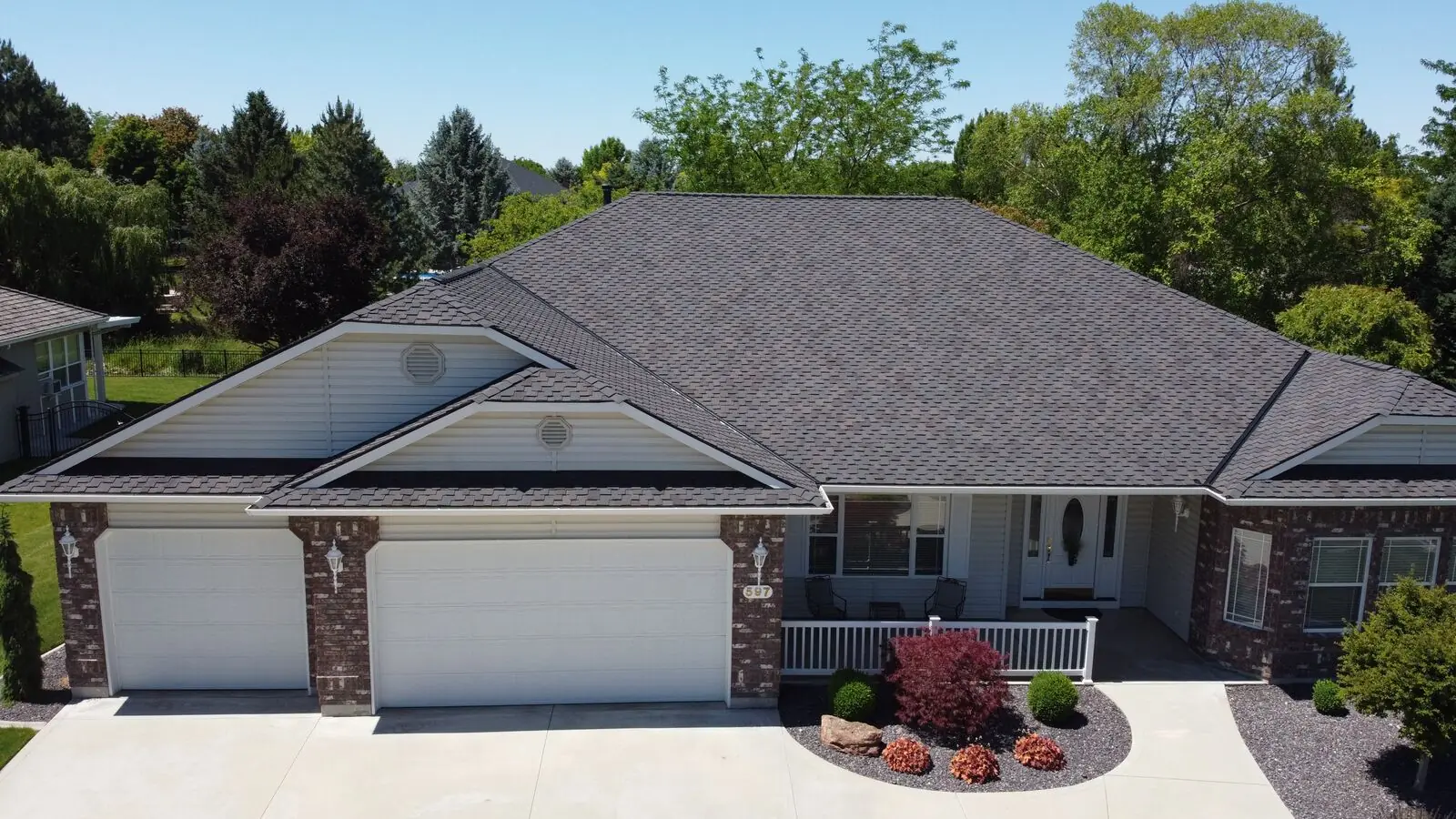 Ranch-style brick home with new charcoal shingle roof in Garden City Idaho